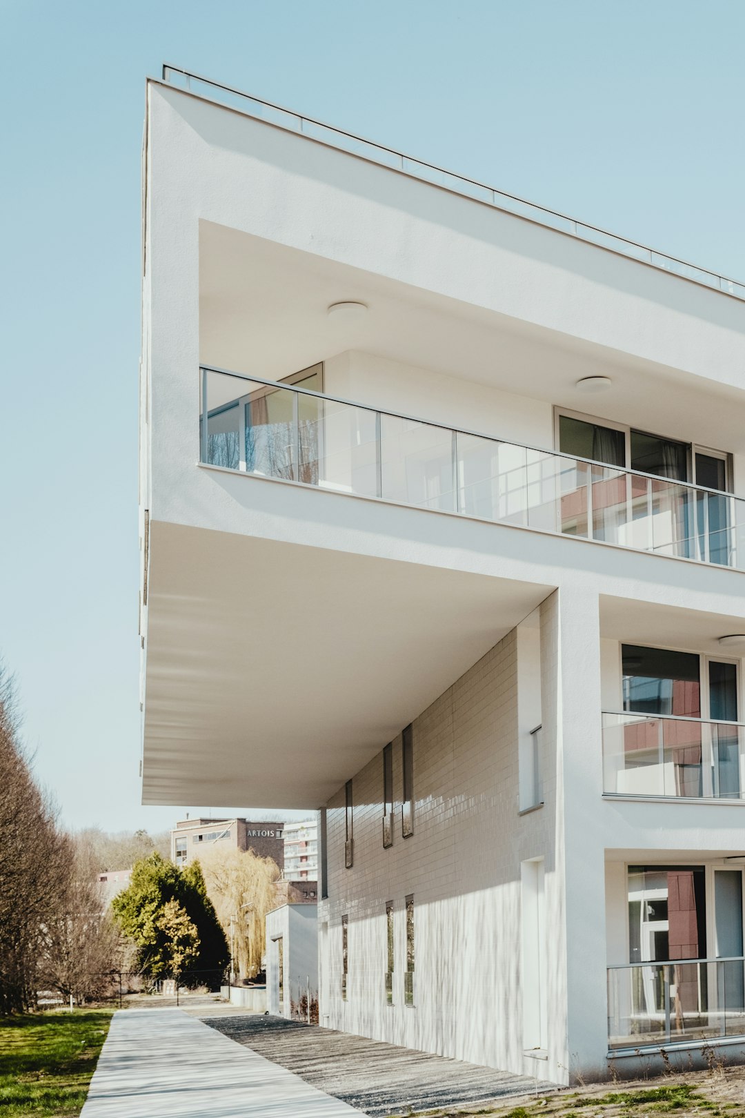 white-concrete-residential-building-near-trees-clkggwibtay
